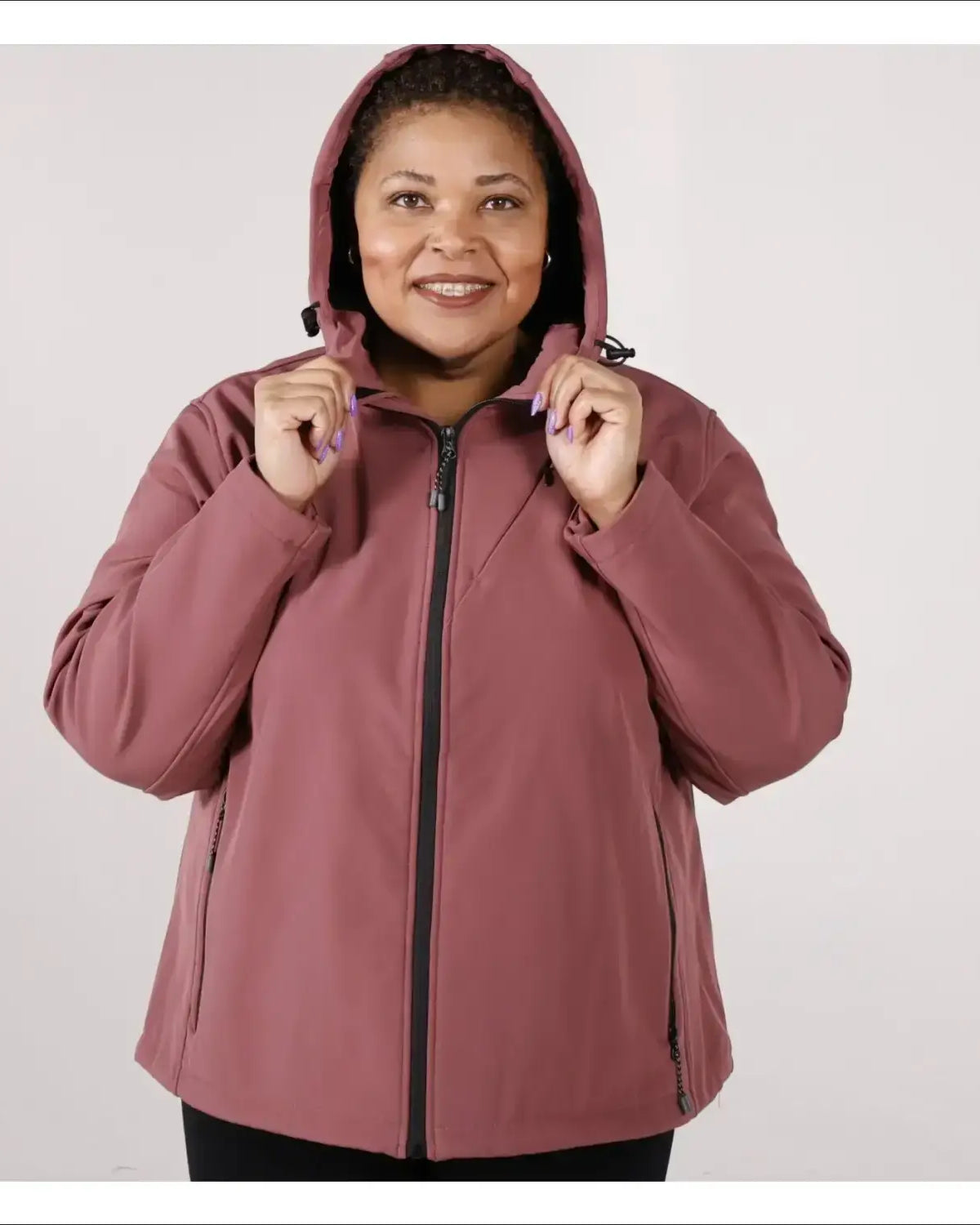 Woman wearing a mauve-colored hooded micro fleece soft shell jacket for plus size outerwear
