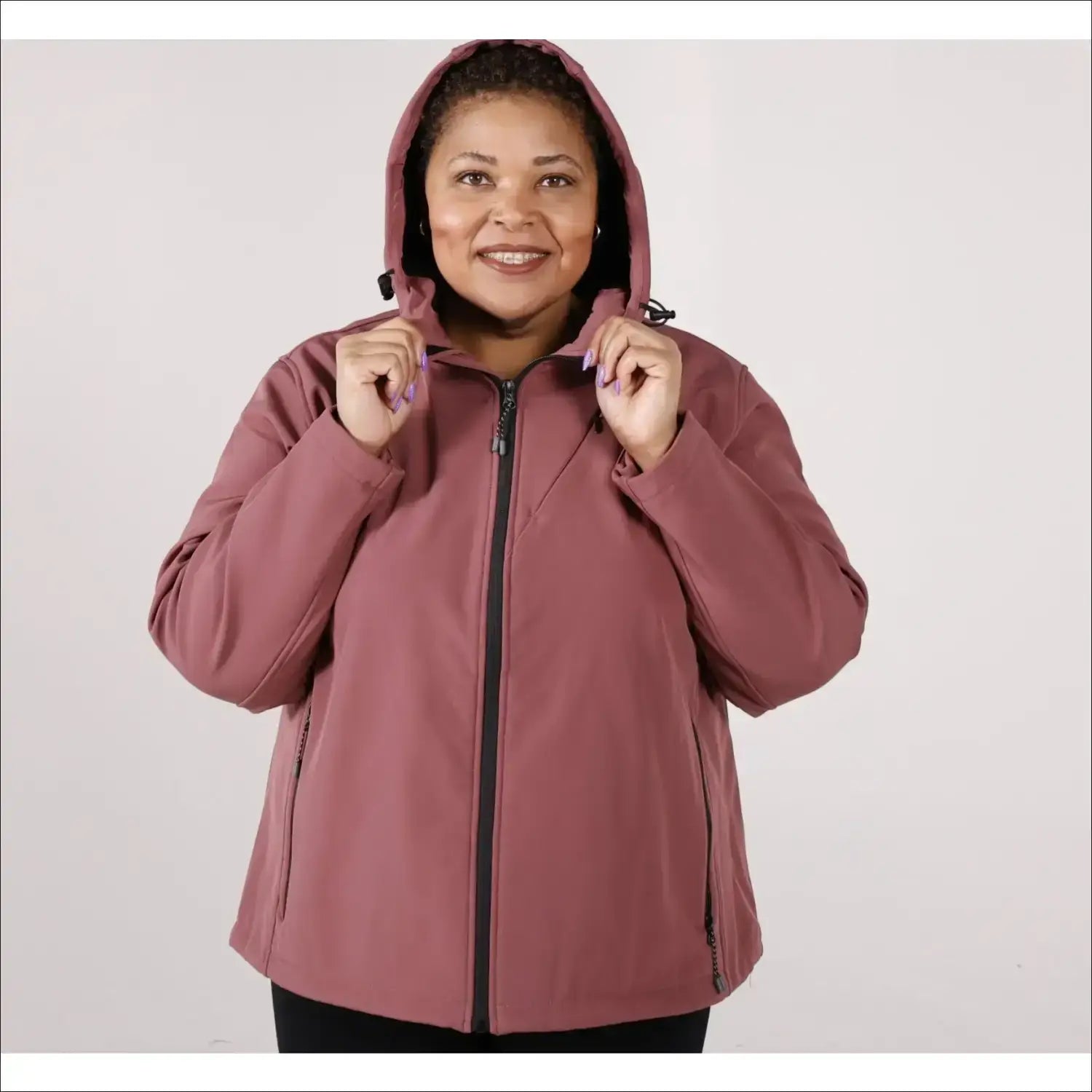 Woman wearing a mauve-colored hooded micro fleece soft shell jacket for plus size outerwear