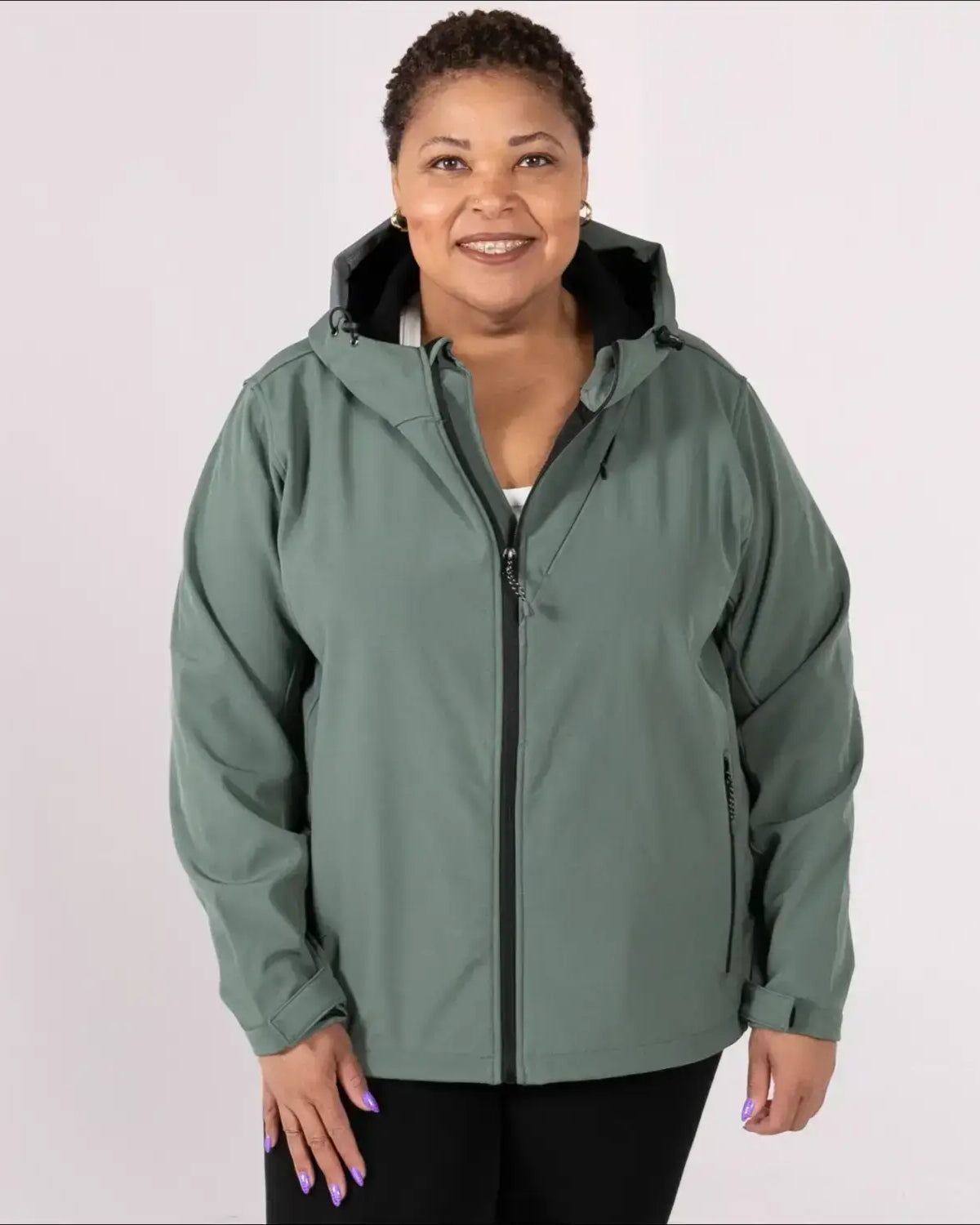 Woman wearing a hooded green plus size fleece soft shell jacket for spring or fall outerwear