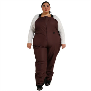 Woman wearing brown insulated bib overalls from Snow Country Outerwear for skiing