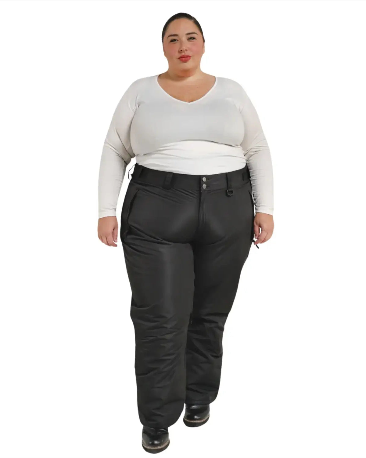 Woman wearing black Snow Country insulated plus size ski pants in a snowy mountain setting