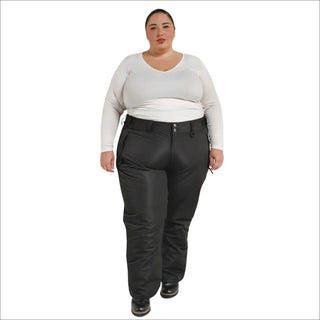 Woman wearing black Snow Country insulated plus size ski pants in a snowy mountain setting