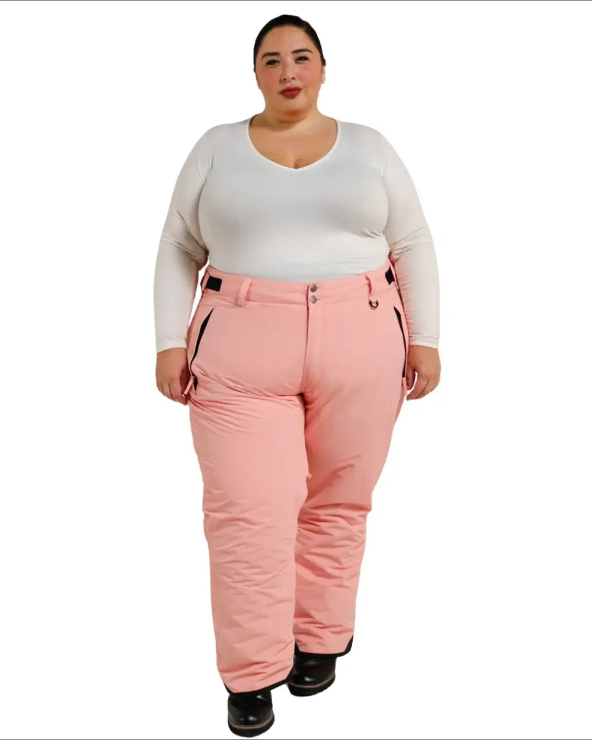 Woman wearing pink snow pants and white long-sleeved shirt for Snow Country Outerwear ski gear