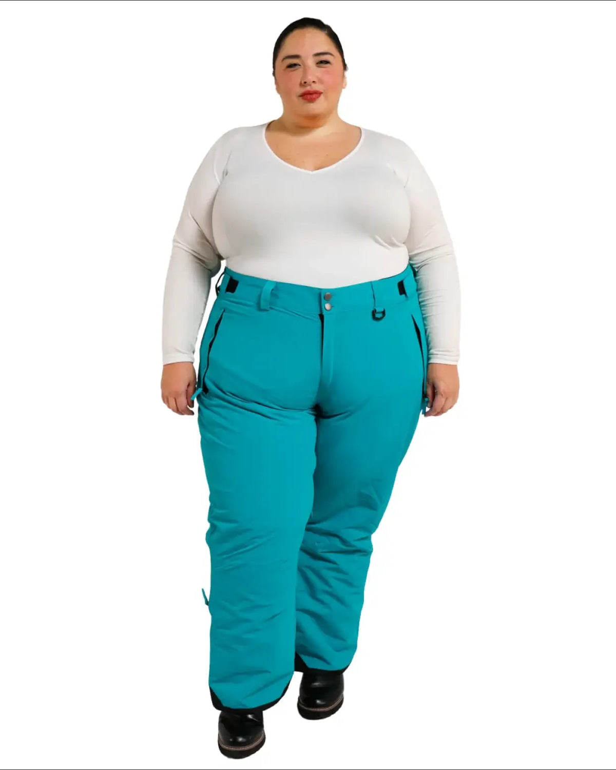 Woman wearing teal insulated ski pants from Snow Country Outerwear for plus size snow skiing