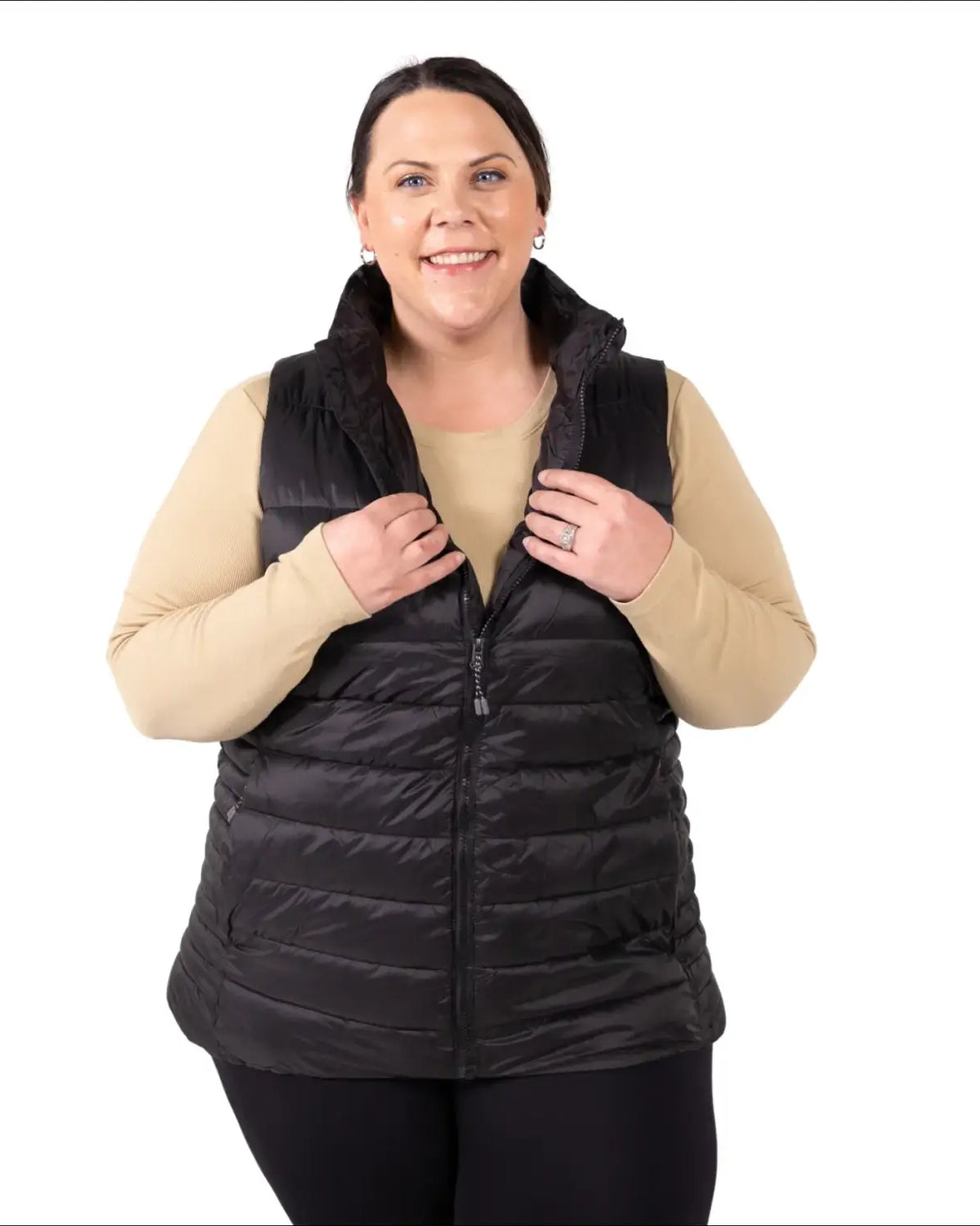 Woman wearing a black puffer vest in women’s plus size synthetic outerwear collection