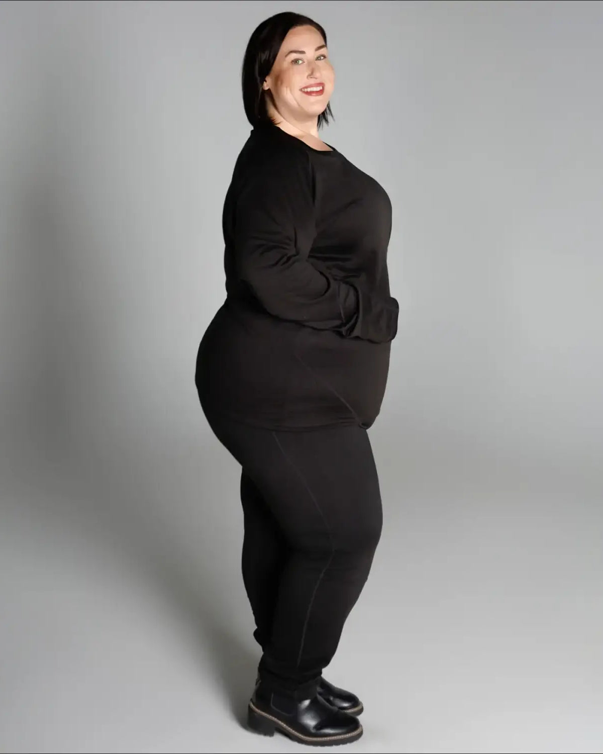 Woman in black outfit wearing Snow Country Outerwear Women’s Plus Size 1X-6X base layer