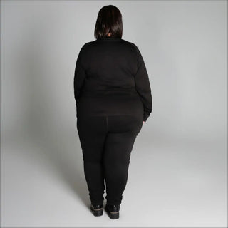 Woman in black athletic wear showcasing Snow Country Outerwear women’s plus size base layer