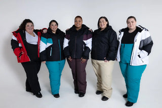 Five plus-size women wearing colorful winter jackets and pants.