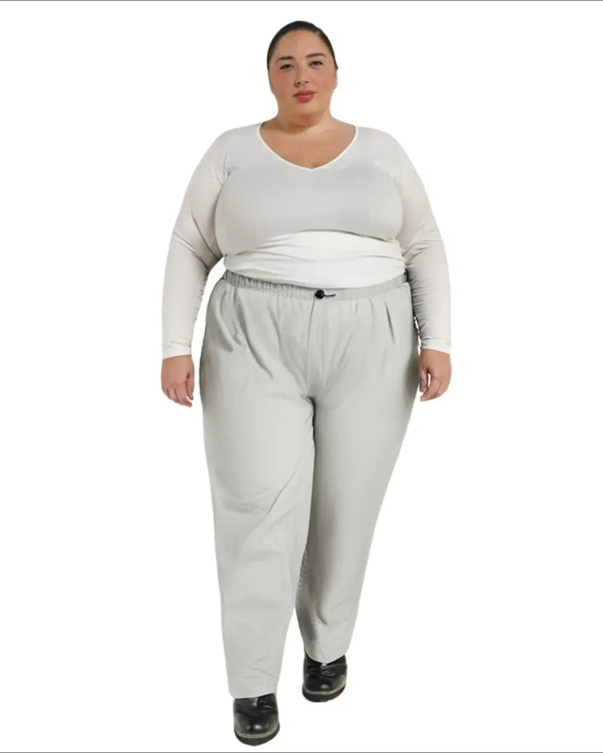 Woman wearing gray packable rain pants and a white top, plus size 1X-6X comfort