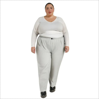 Woman wearing gray packable rain pants and a white top, plus size 1X-6X comfort