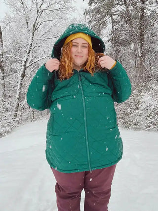 Green plus size snow jacket on a woman in winter