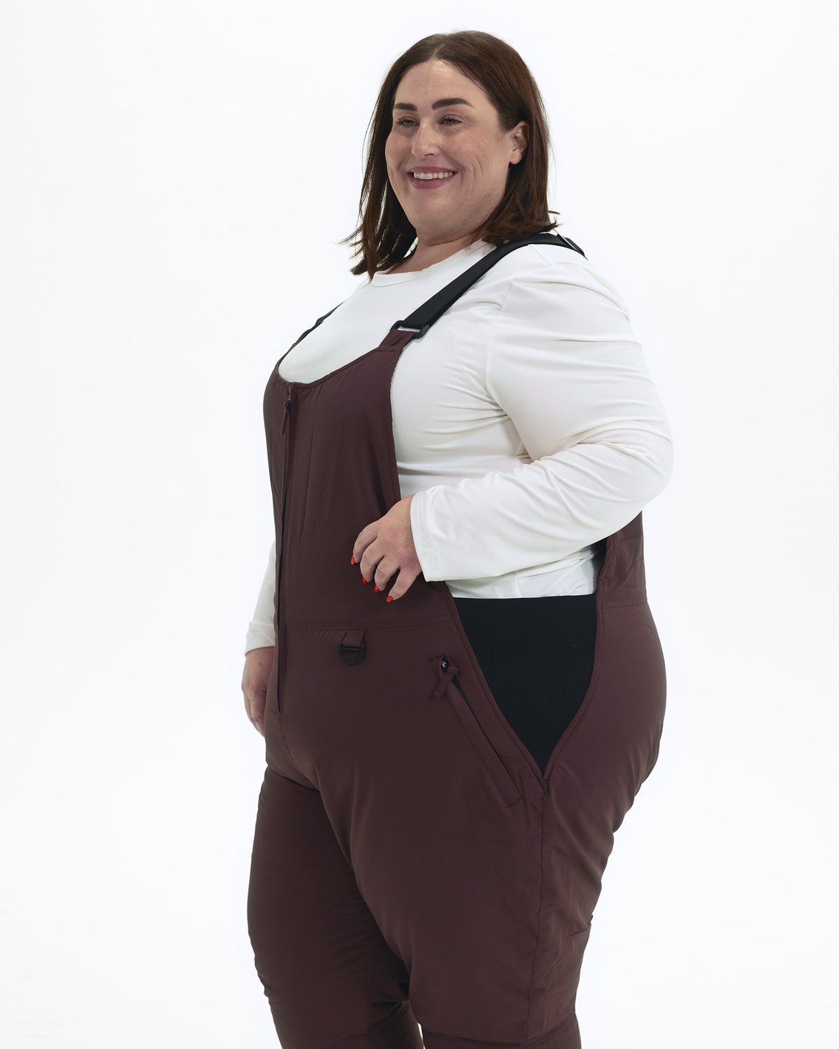 Eggplant women's plus size Overland snow bibs, three quarter | Model is 5'4" and wears a 3X