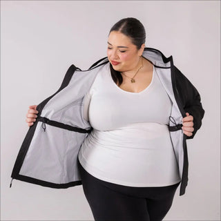 Woman wearing a black rain jacket with white lining from Plus Size 1X-6X Women’s Rain Jacket Wind Breaker Mystique