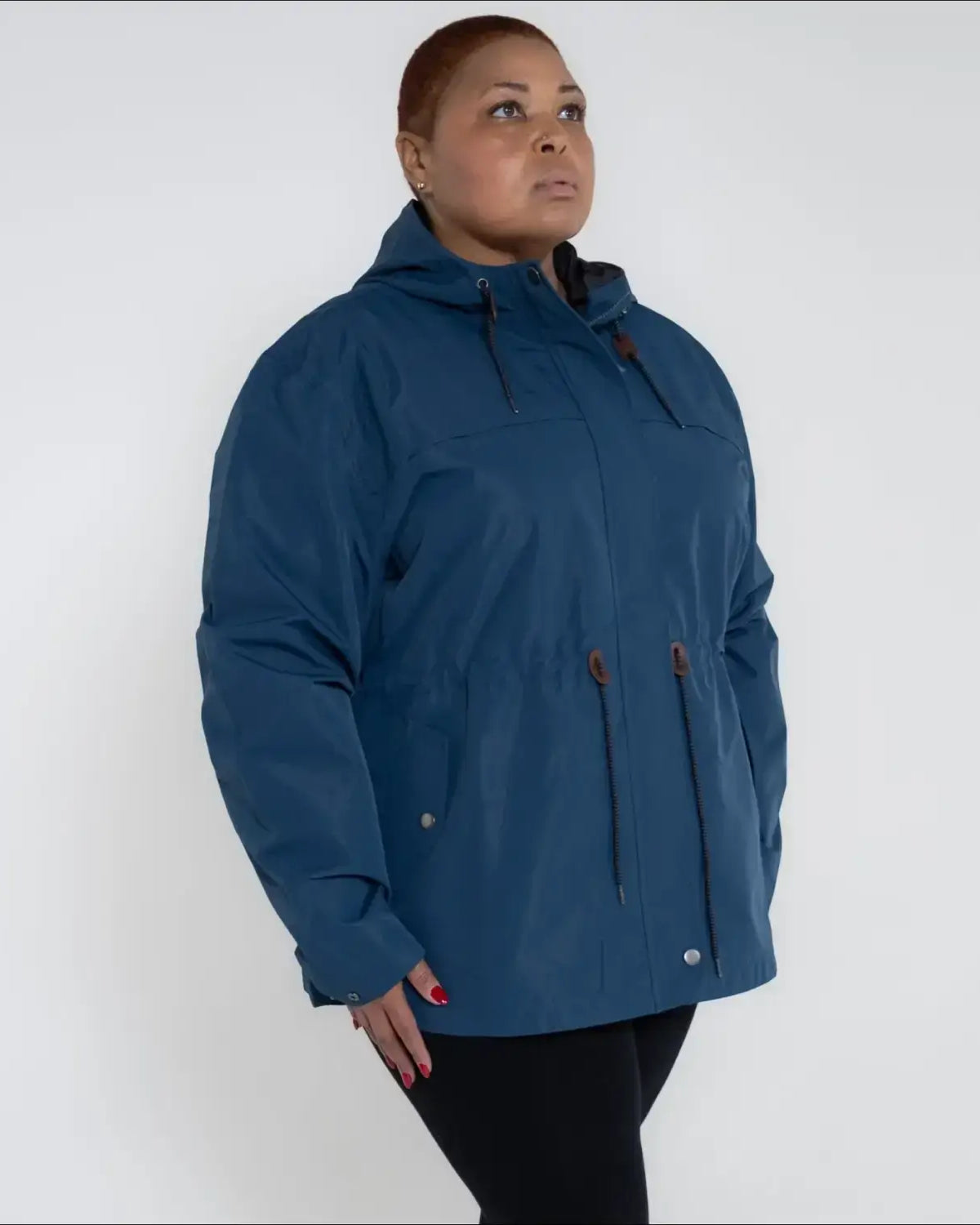 Blue plus size rain jacket on model, side image