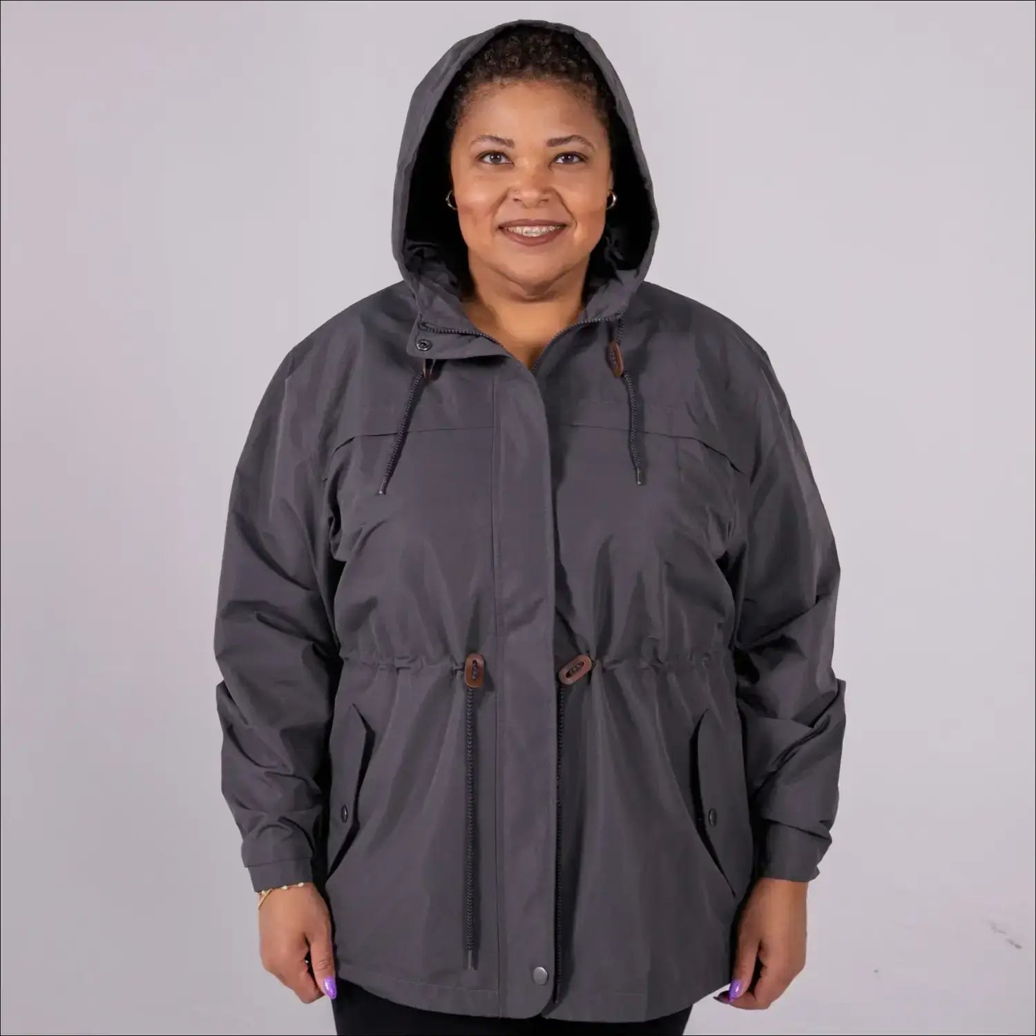 Gray plus size rain jacket on model, front image with hood up