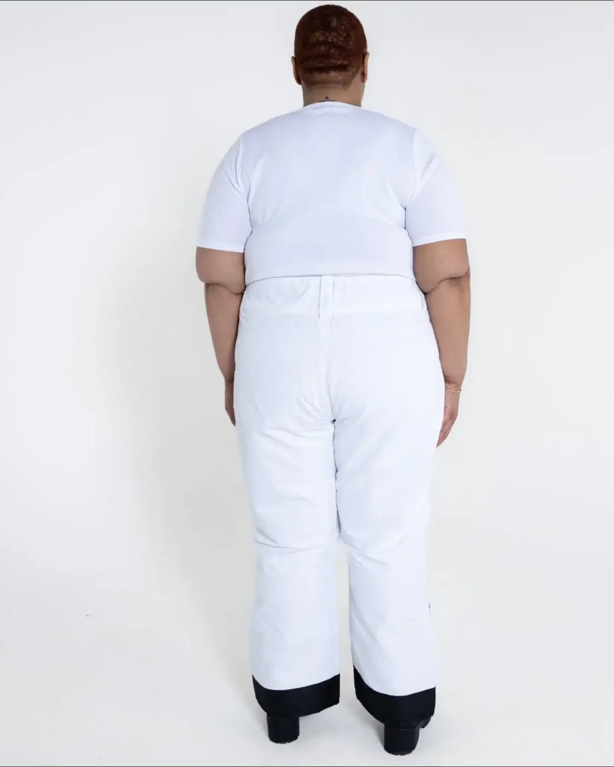 White ski pants with black cuffs from Snow Country Outerwear women’s plus size insulated ski pants
