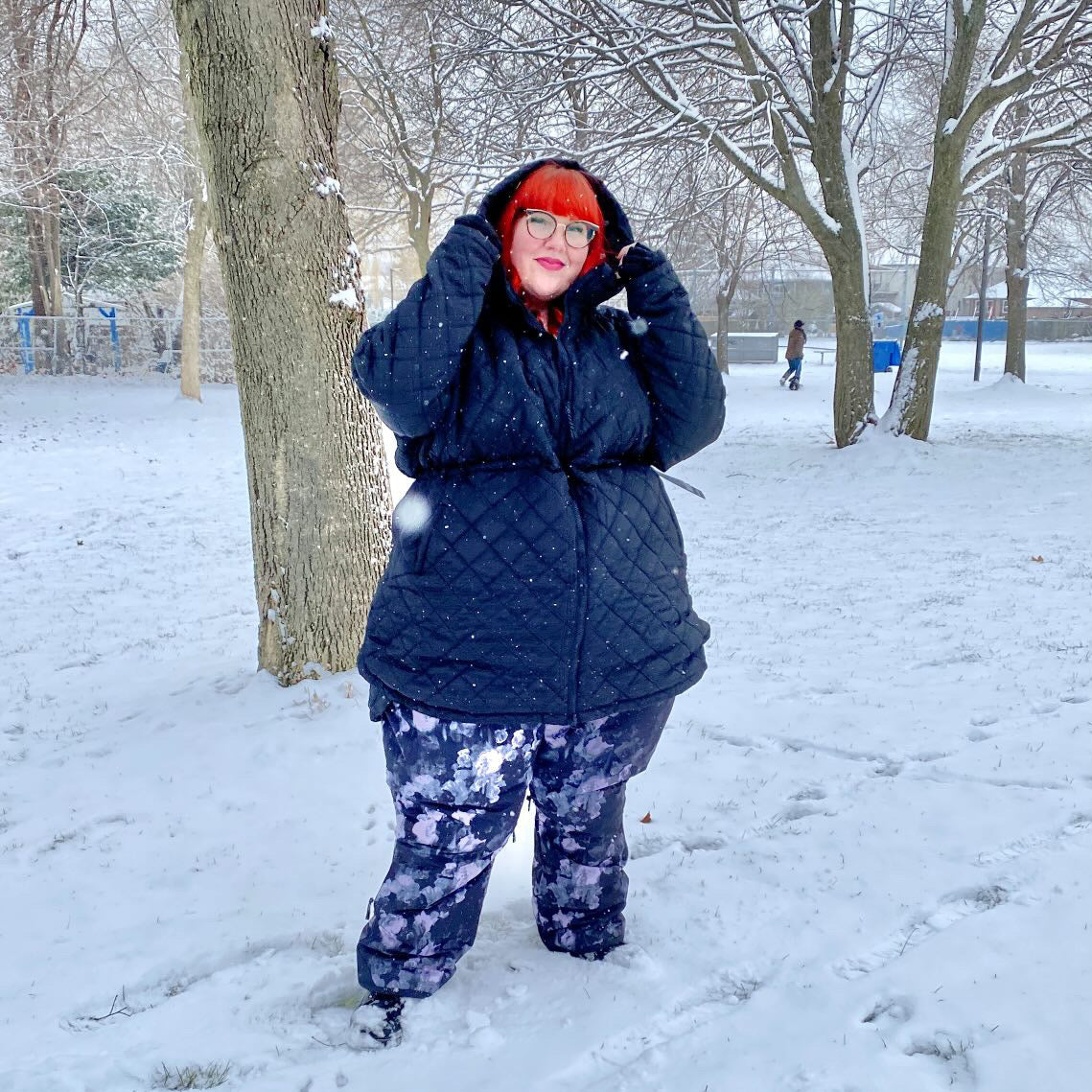 Plus size snow pants and plus size snow jacket on a woman outdoors