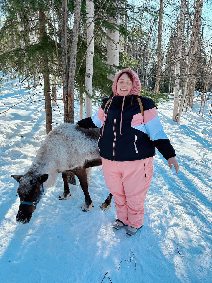 pink plus size snow pants and pink plus size snow jacket on a woman