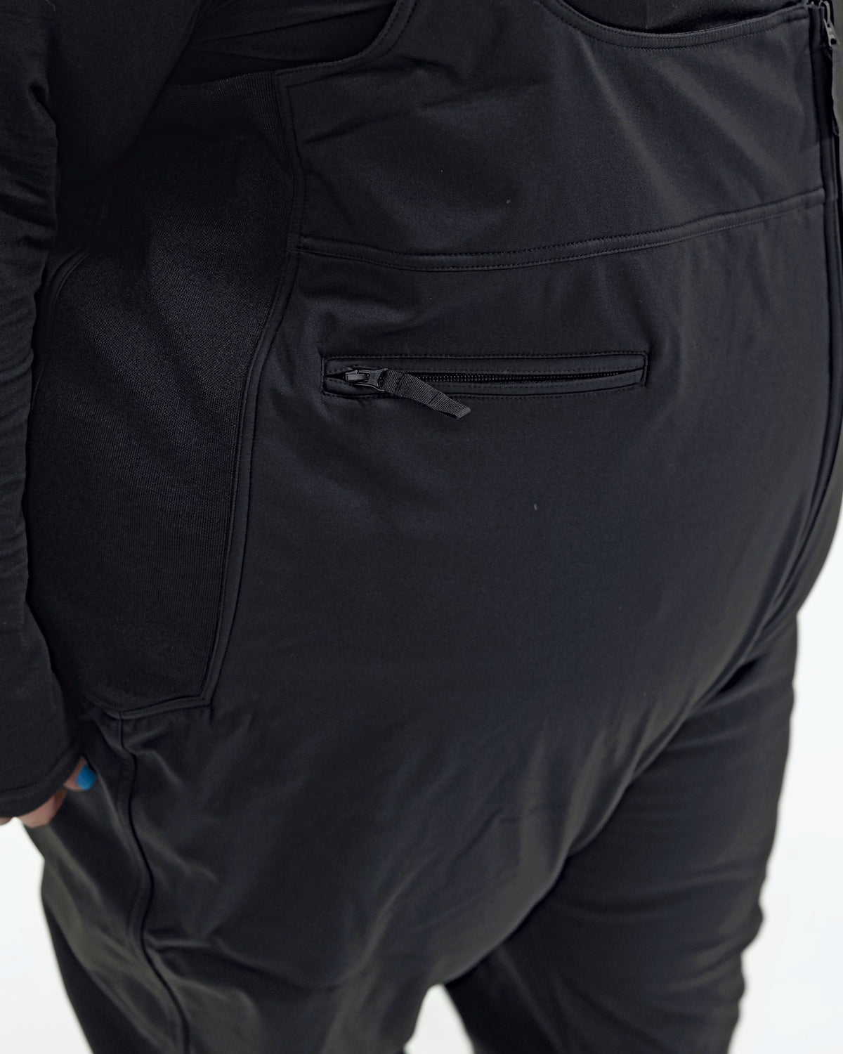 Black women's plus size soft shell snow bibs, zippered side pocket detail