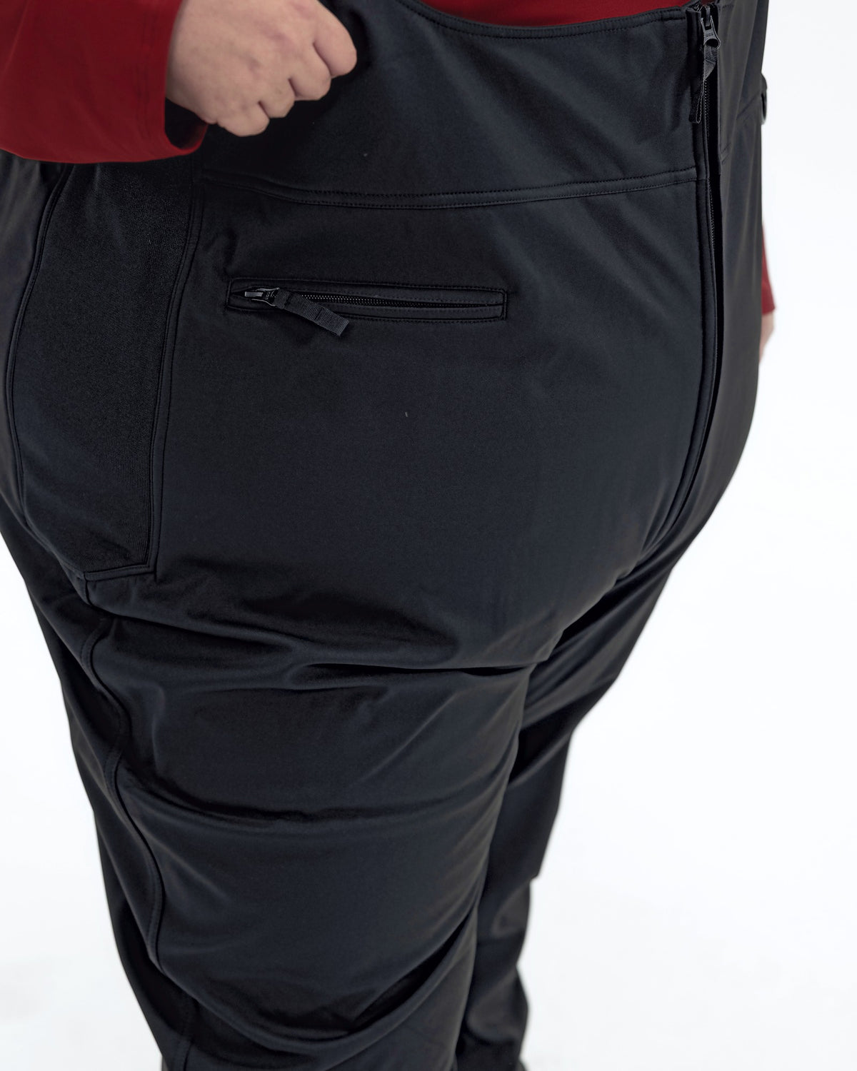 Black women's plus size soft shell snow bibs, back zip pocket detail