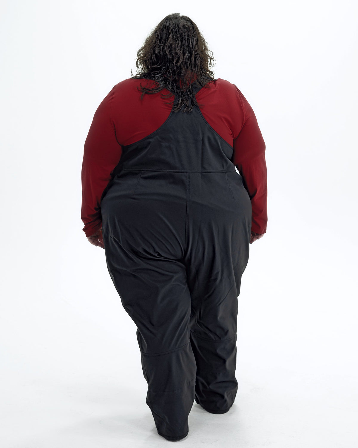 Black women's plus size soft shell snow bibs, back | Model is 5'4" and wears a 5X