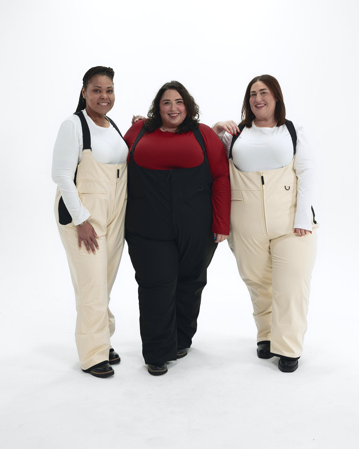 Women's plus size soft shell snow bibs, sizes 1X to 6X, worn by three models in Vanilla and Black