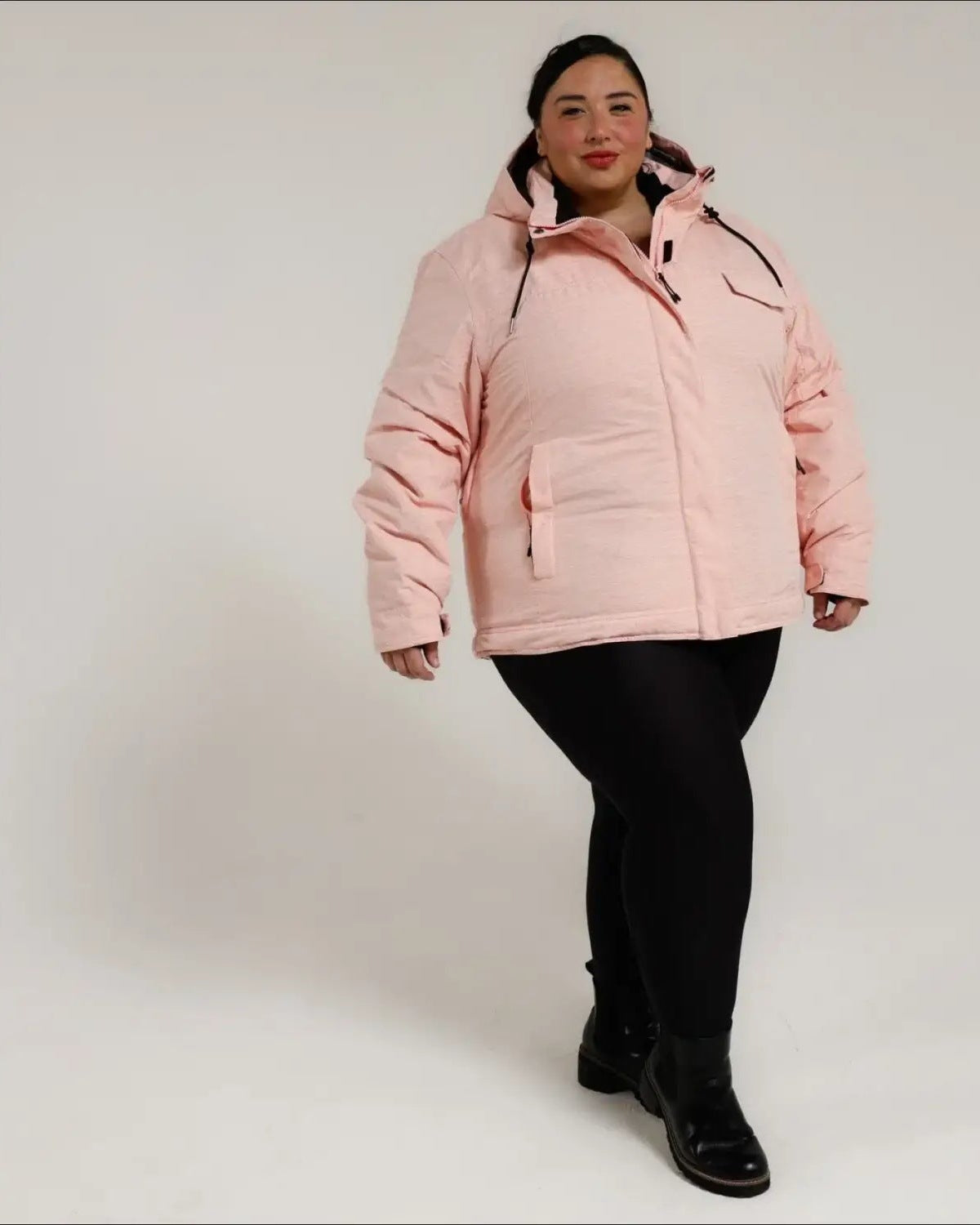 Woman wearing a pink puffer insulated snow board ski winter coat in Sugarcoat outerwear
