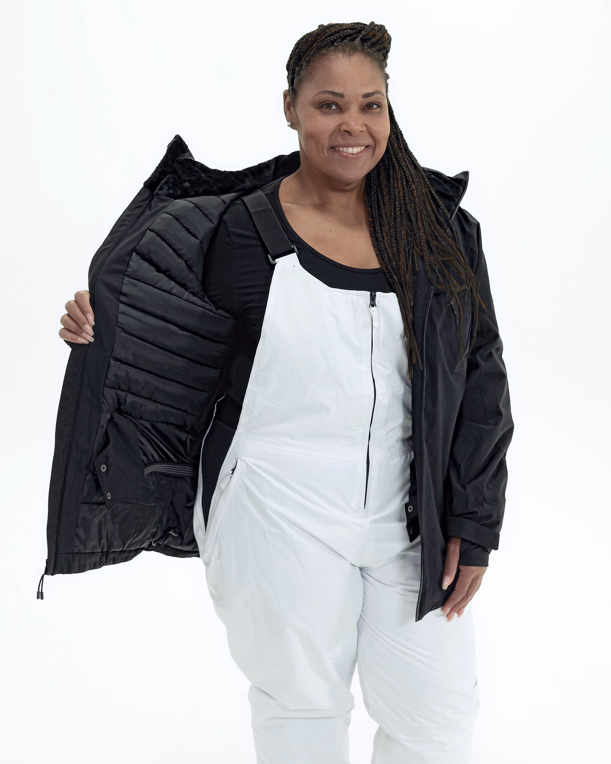 Black The Tempest plus size insulated snow jacket, worn open over snow bibs | Model is 5'6" and wears a 1X