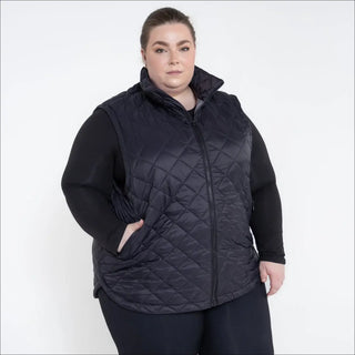 Woman wearing a stylish black quilted insulated vest from Savvy Outerwear Plus Size collection