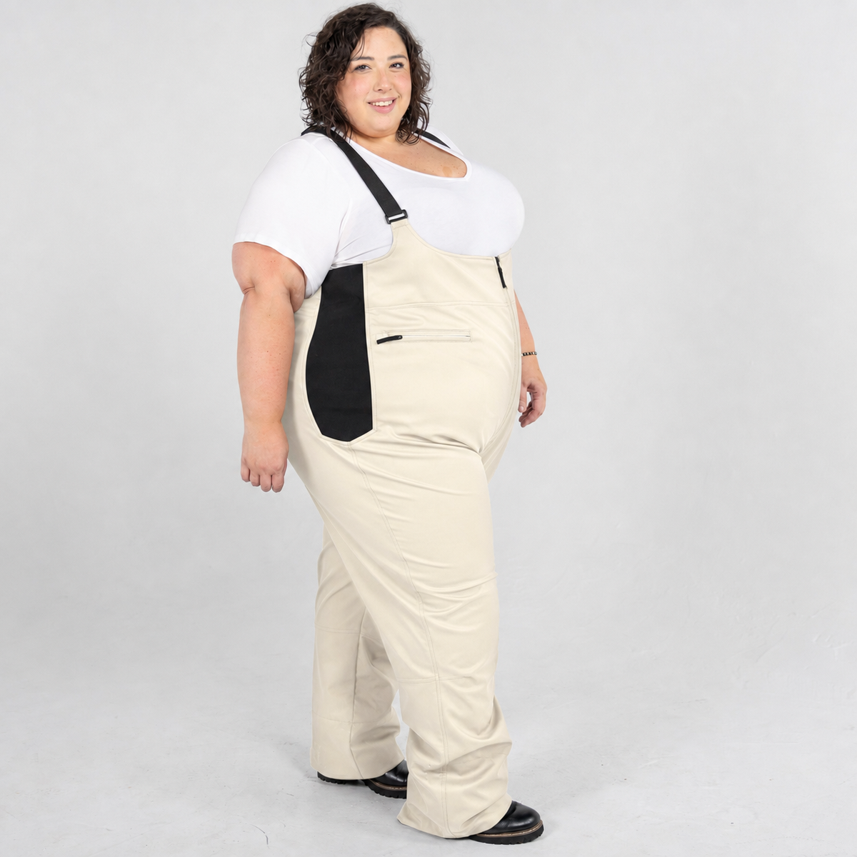 Vanilla plus size soft shell ski snow bibs, side view on model