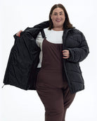 Black Geneva women's plus size mid length synthetic down jacket, worn open