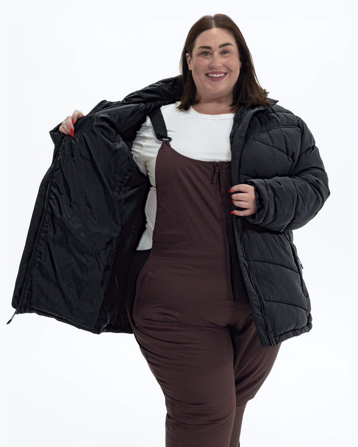Black Geneva women's plus size mid length synthetic down jacket, worn open