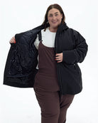 Black Swiss Systems women's plus size 3 in 1 winter jacket, shell worn open over the zip-in quilted liner