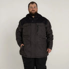 Man wearing a black and gray Snow Country Outerwear insulated winter parka coat