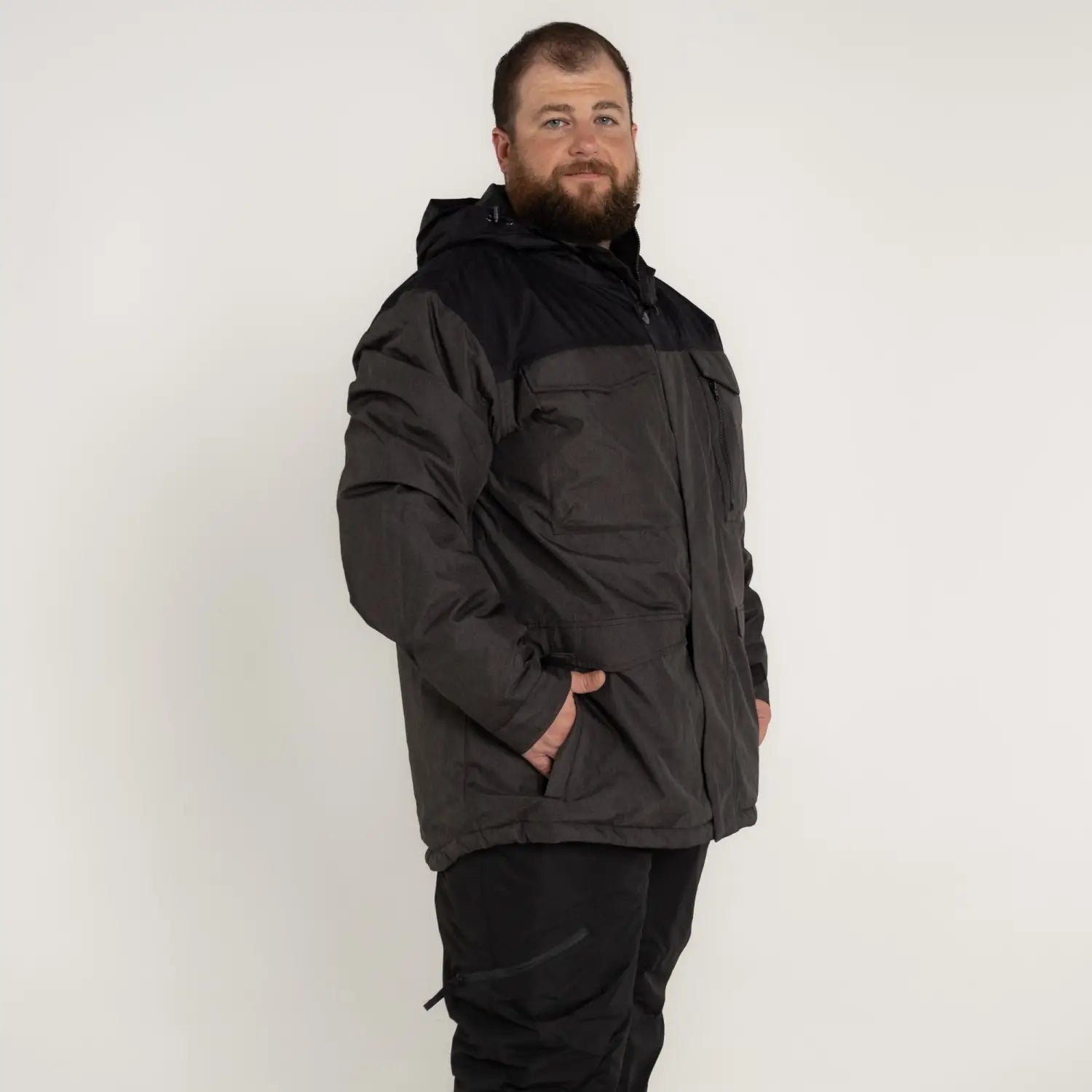 Man in a black and gray insulated winter parka from Snow Country Outerwear for big sizes