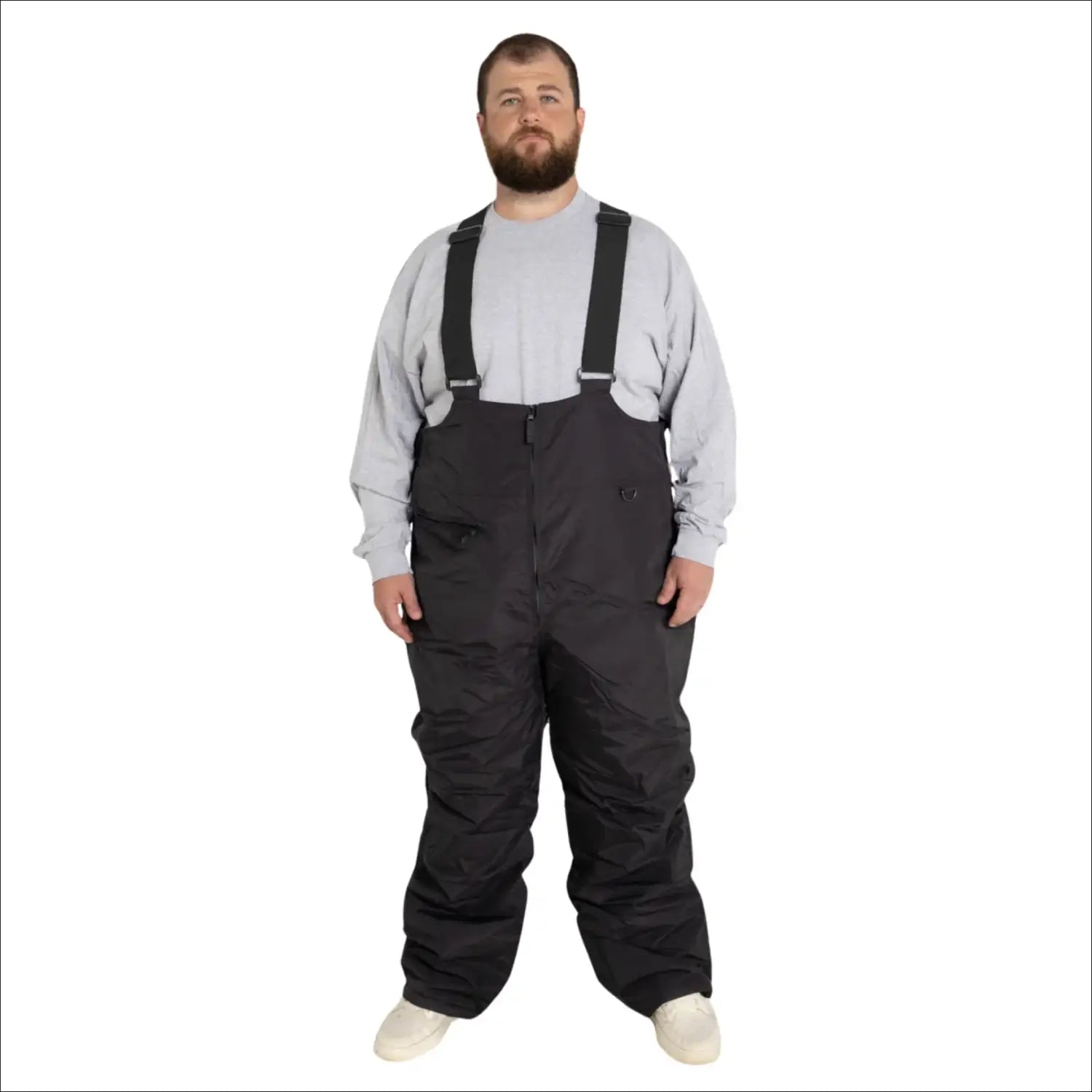 Man wearing black Snow Country Outerwear insulated ski snow bibs with suspenders