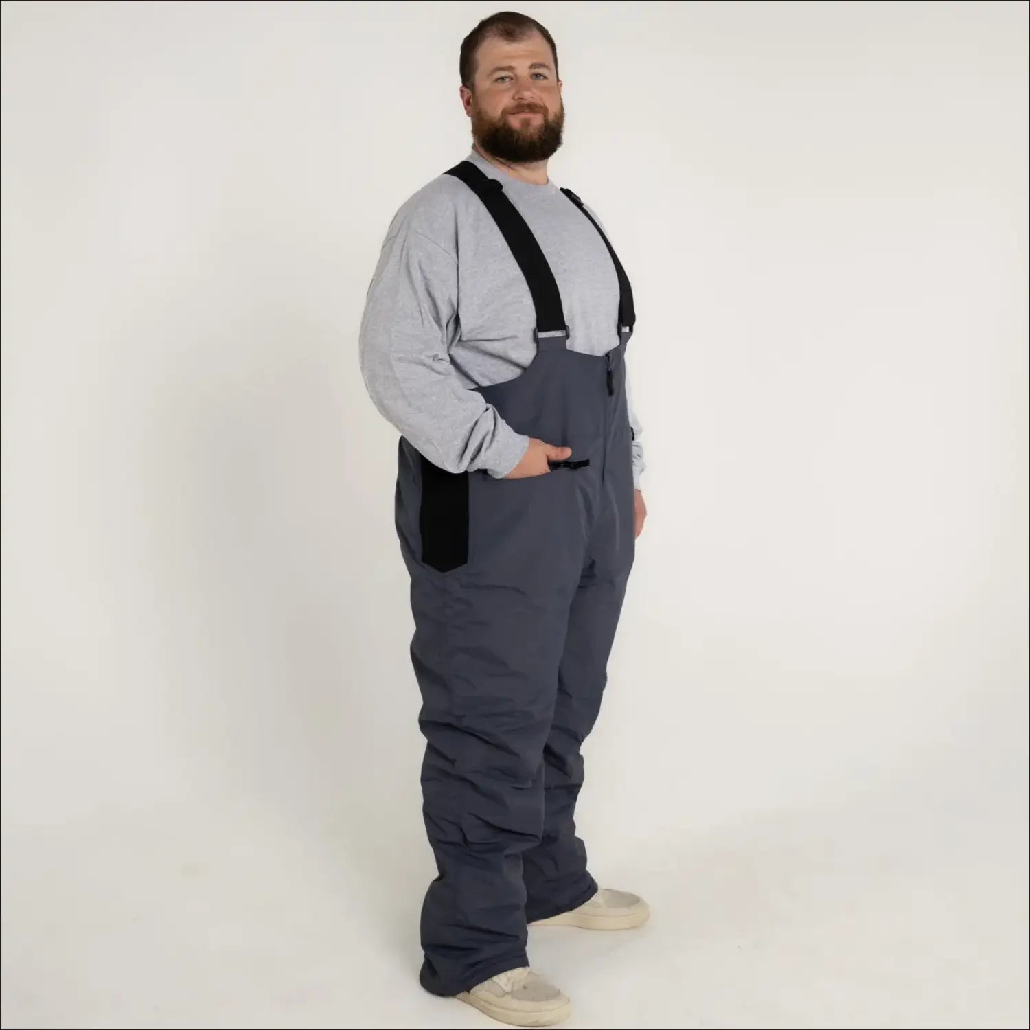 Man in gray Snow Country insulated ski snow bibs with suspenders for big and tall sizes