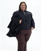 Black Swiss Systems women's plus size 3 in 1 winter jacket, quilted liner jacket with the shell over her arm