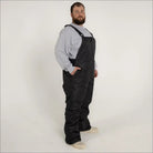 Black insulated bib overalls for men from Snow Country Outerwear, perfect for winter skiing
