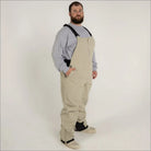 Man wearing tan Snow Country Outerwear Ski Snow Bib Overalls Pants for men