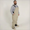 Man wearing tan Snow Country Outerwear skiing bib overalls in a product image