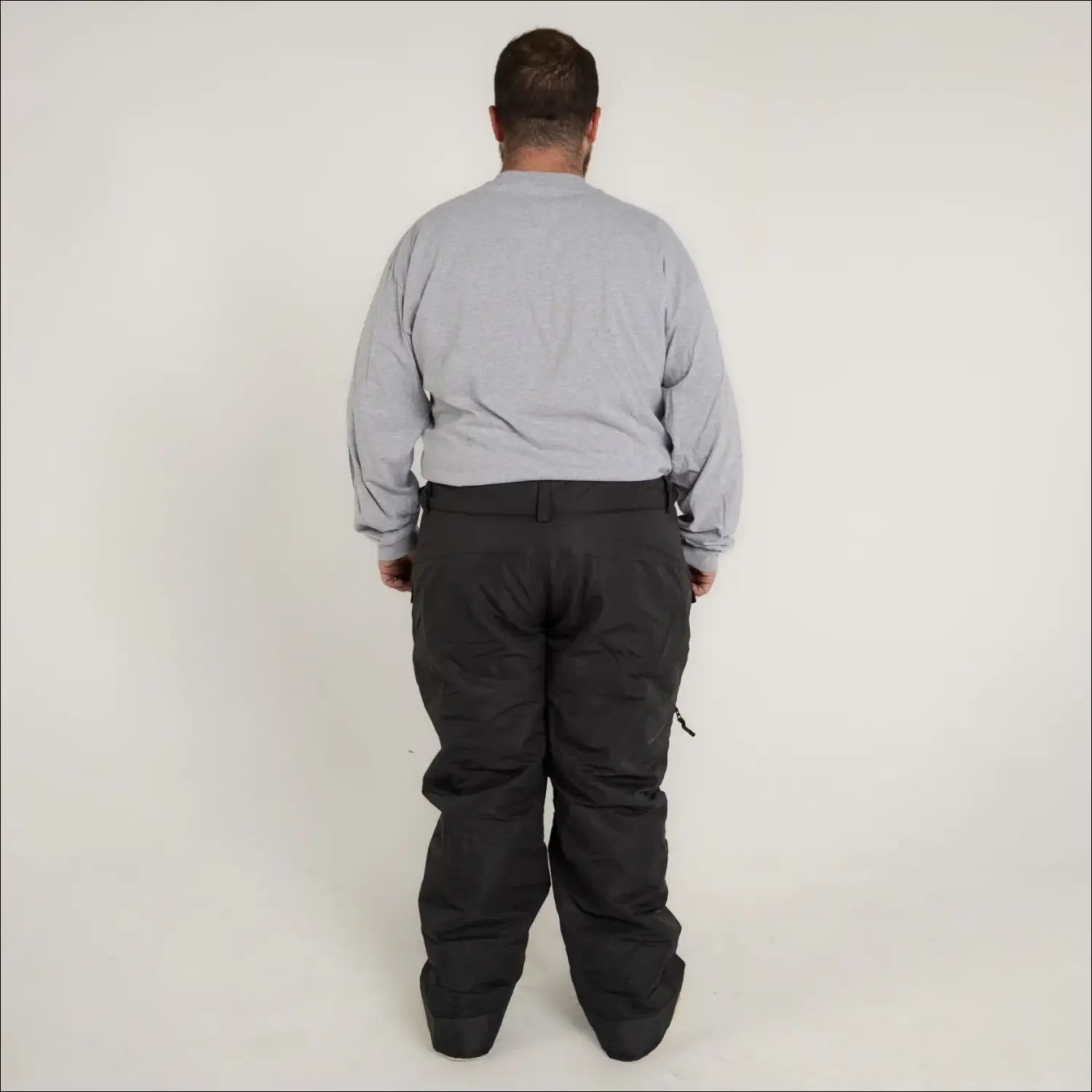Man wearing gray shirt and black pants in Snow Country Insulated Ski Snow Pants