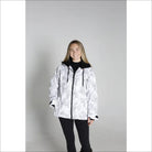 Woman wearing a white and gray camouflage Snow Country Women’s Ski Coat for winter sports
