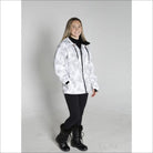 Woman wearing a white camouflage Snow Country outerwear winter ski coat