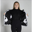 Woman showing the inside of a White and Black Snow Country Womens Ski Coat Jacket