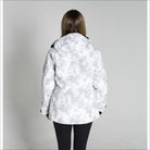 Woman wearing a white and gray camouflage Snow Country Women’s ski coat for winter snowboarding