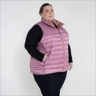 Woman wearing a pink puffer vest from Women’s Plus Size 1X-6X Synthetic Down Outerwear