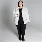 Woman wearing a white puffer jacket from Snow Country Outerwear Plus Size Lexington collection