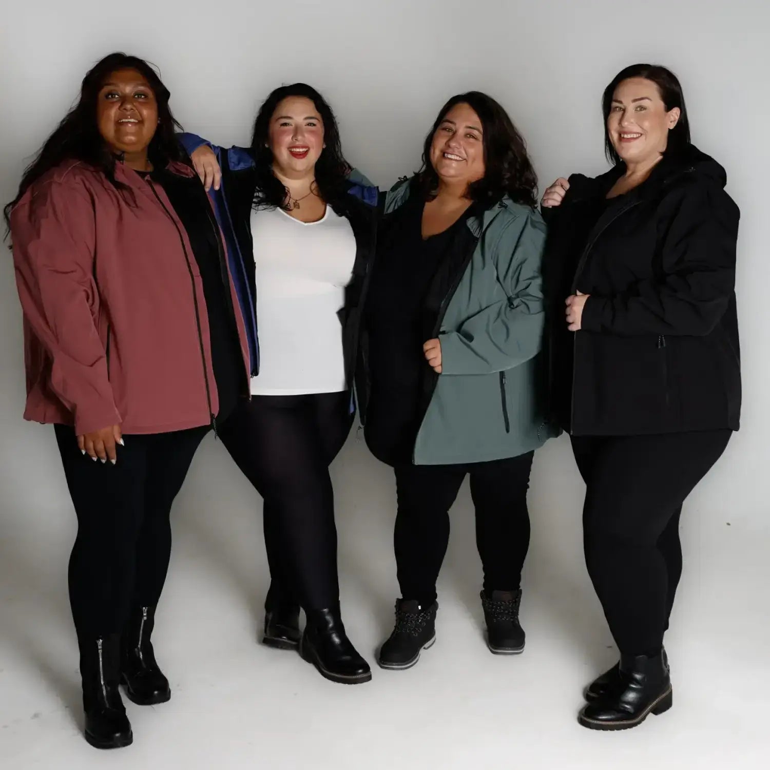 Four plus-size women wearing Micro Fleece Soft Shell jackets in spring or fall weather