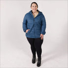 Woman in blue puffer jacket wearing Women’s 1X-6X Plus Extended Size Packable Down Jacket Hooded Coat Snow Country Outerwear